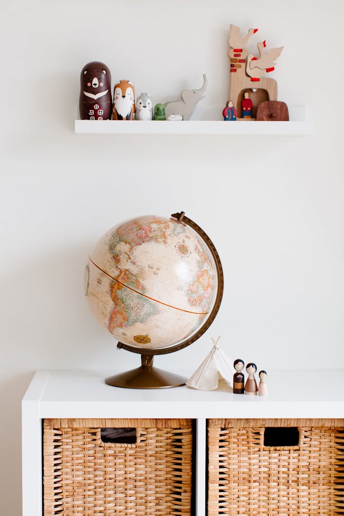 Cozy childrens room with globe and toys, blending modern and vintage decor styles.